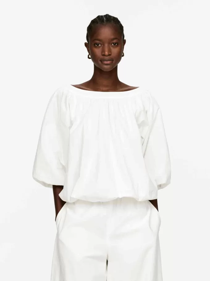 Top con dobladillo abullonado Top con dobladillo abullonado